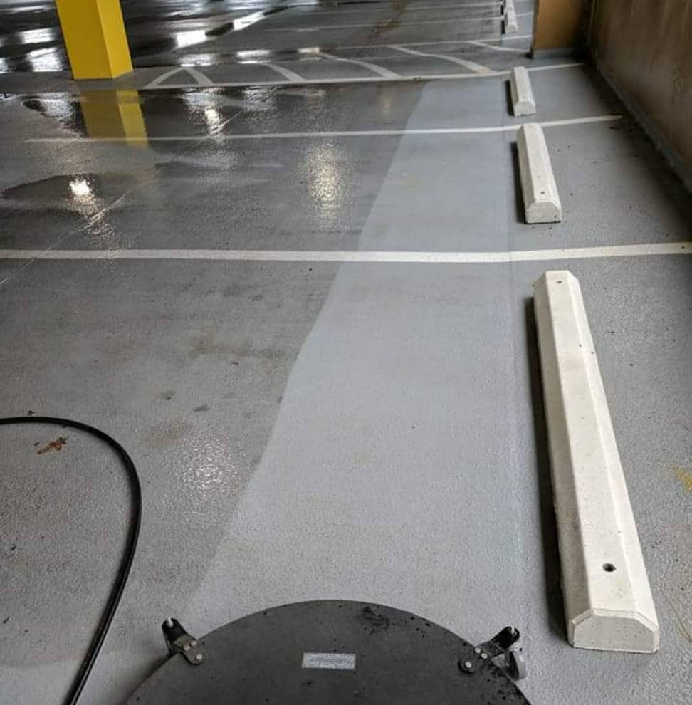 Before and after of exterior property cleaning services in Halifax of a parkade.