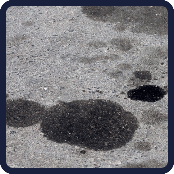 Oil stained concrete driveway before pressure washing in Halifax