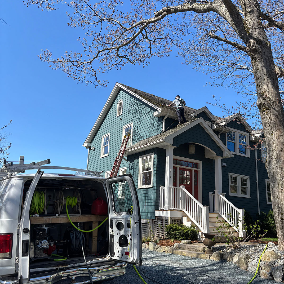 ProCare's professional roof washing in Bedford, NS showing our safe fall-arrest practices.