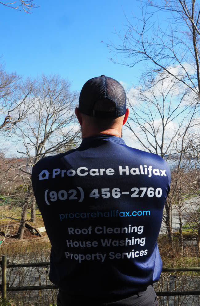 JJ standing with his back to the camera, showcasing the newly branded work shirts.